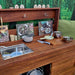 Bellbird outdoor mud kitchen with accessories angle view